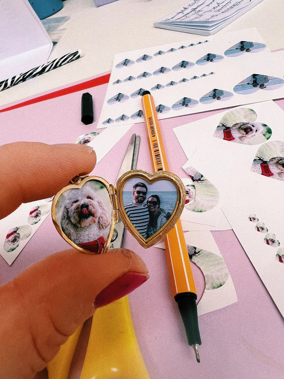 An open vintage heart locket fitted with family and pet photographs