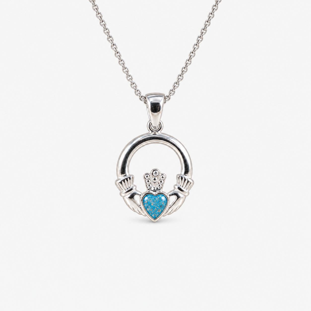 Claddagh Ashes Necklace in Sky Blue with visible ashes