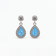 Crystal Halo Teardrop Ashes Earrings — Sky Blue, visible ashes