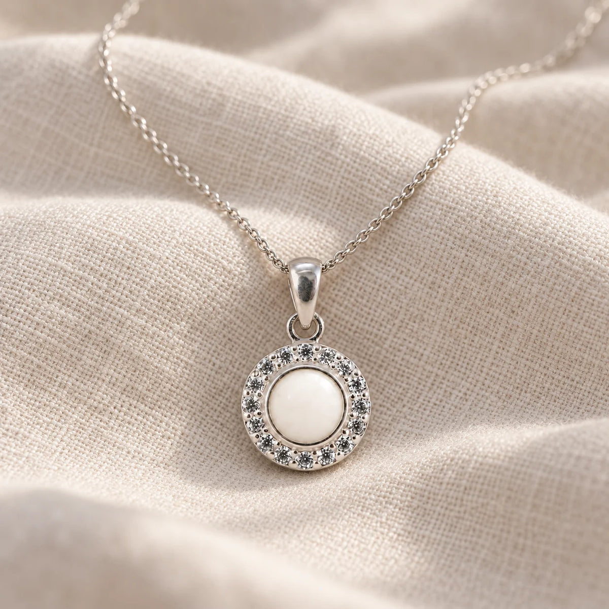 Dainty Halo Breast Milk Necklace on pale linen — illustrative preview