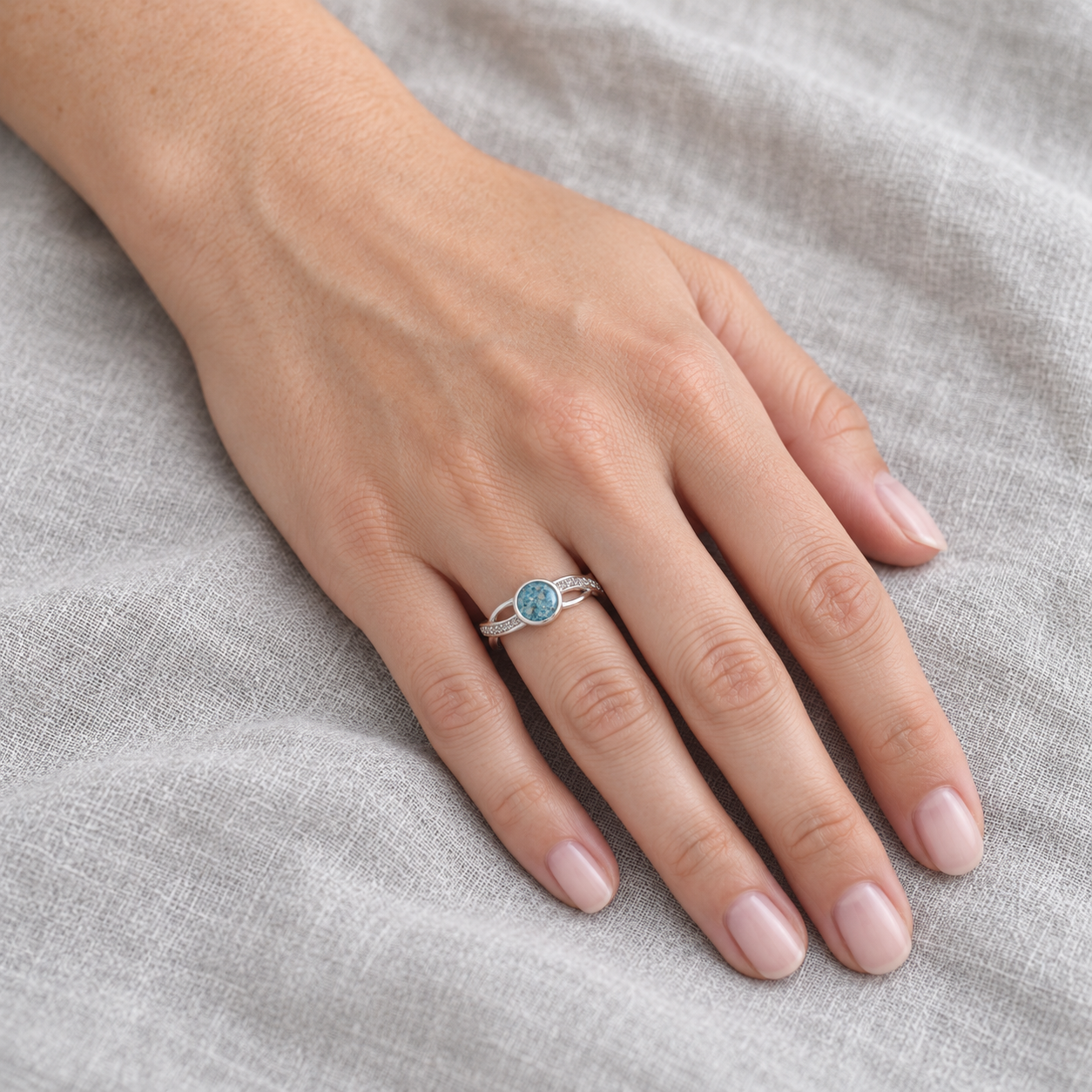 entwined ashes ring in Sky Blue, shown at natural scale