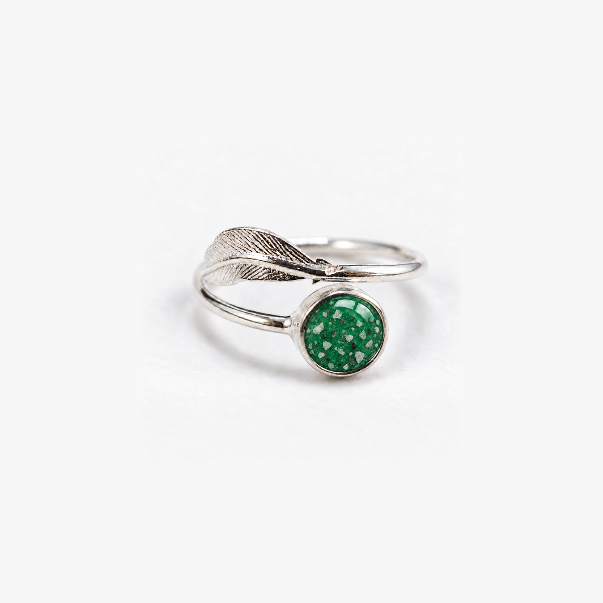 Feather Ashes Ring in Emerald with visible ashes