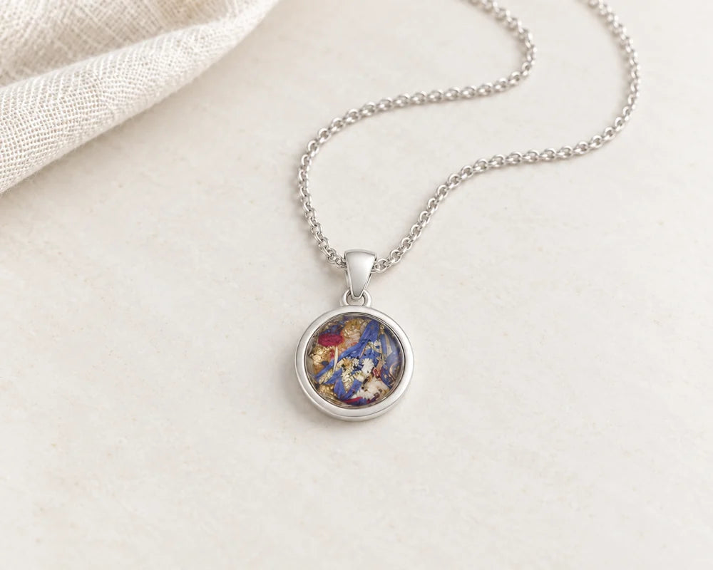 Dried flower necklaces on pale stone and ivory linen
