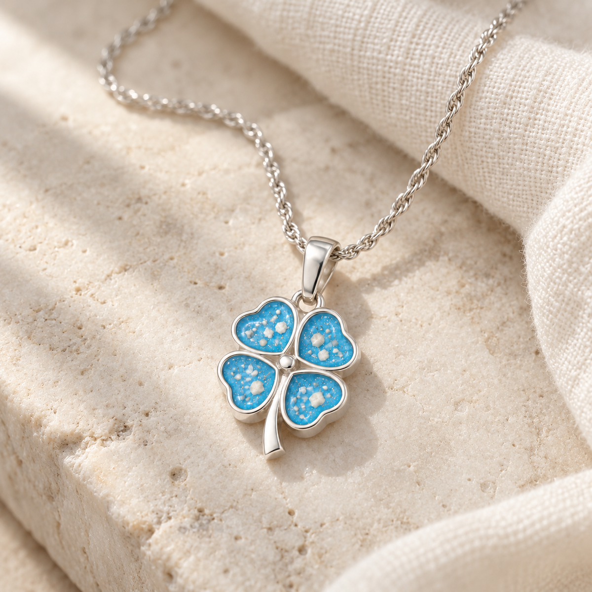 Illustrative lifestyle view of Four Leaf Clover Ashes Necklace — Sky Blue, visible ashes