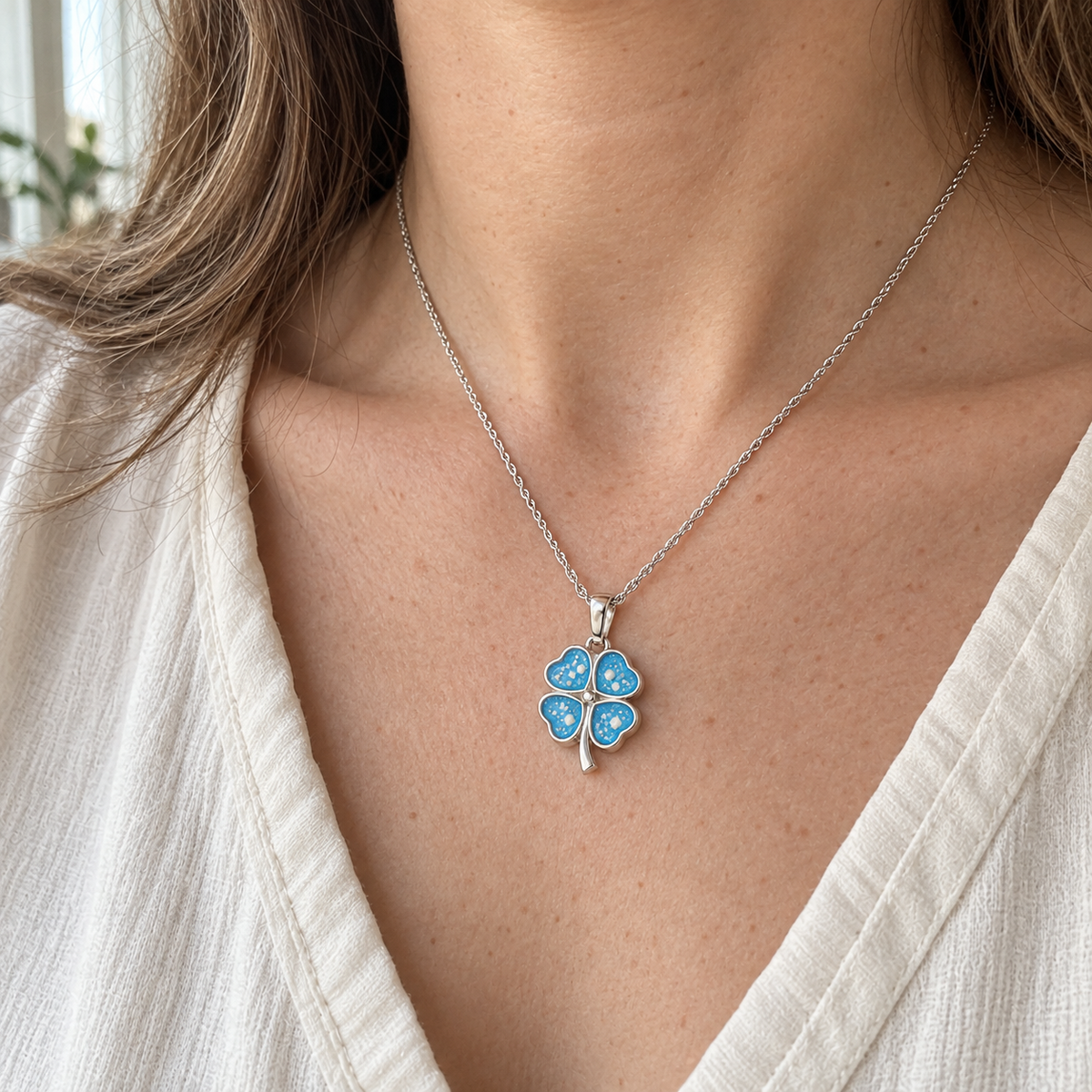 Illustrative worn view of Four Leaf Clover Ashes Necklace — Sky Blue, visible ashes