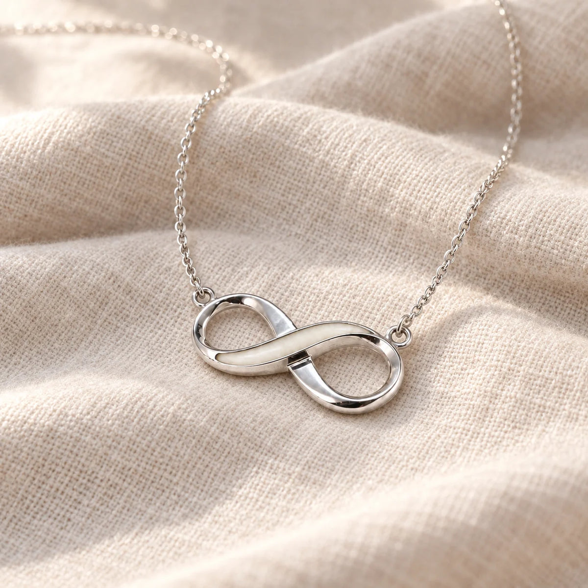Infinity Breast Milk Necklace on pale linen — illustrative preview