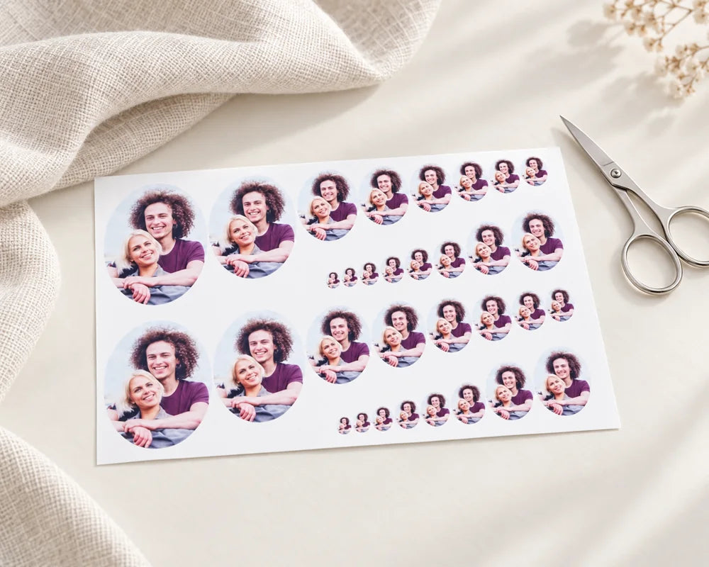 Miniature oval photo prints in different sizes on a linen desk