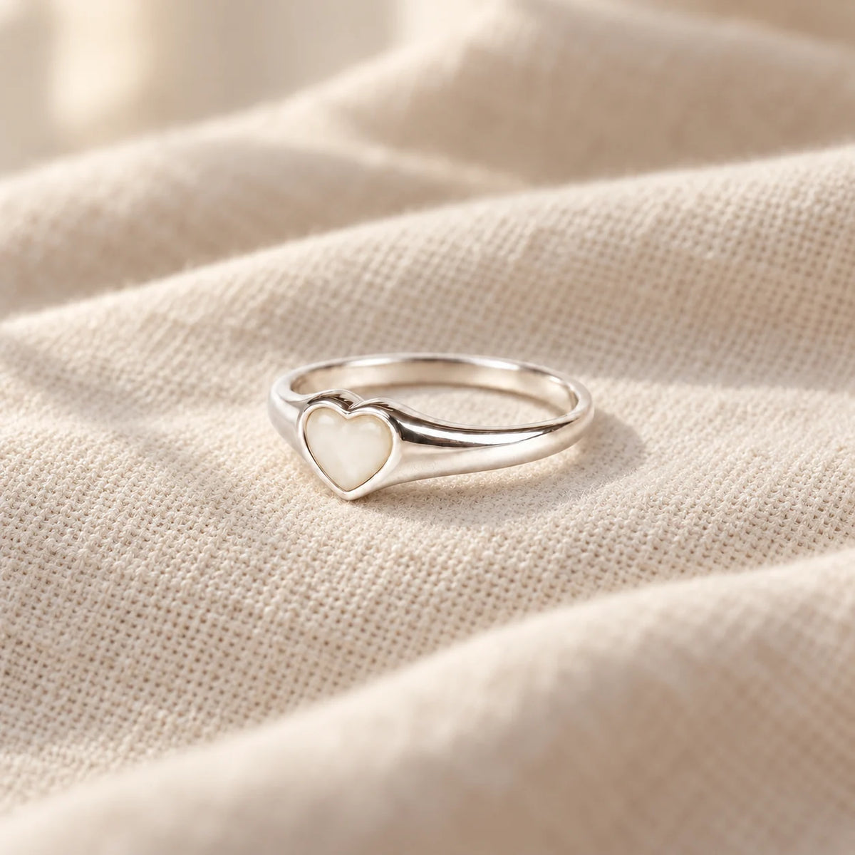 Petite Heart Breast Milk Ring on pale linen — illustrative preview