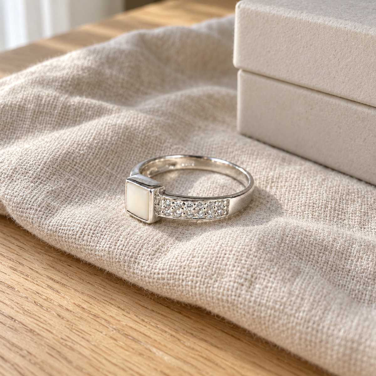 Illustrative lifestyle view of square crystal breast milk ring