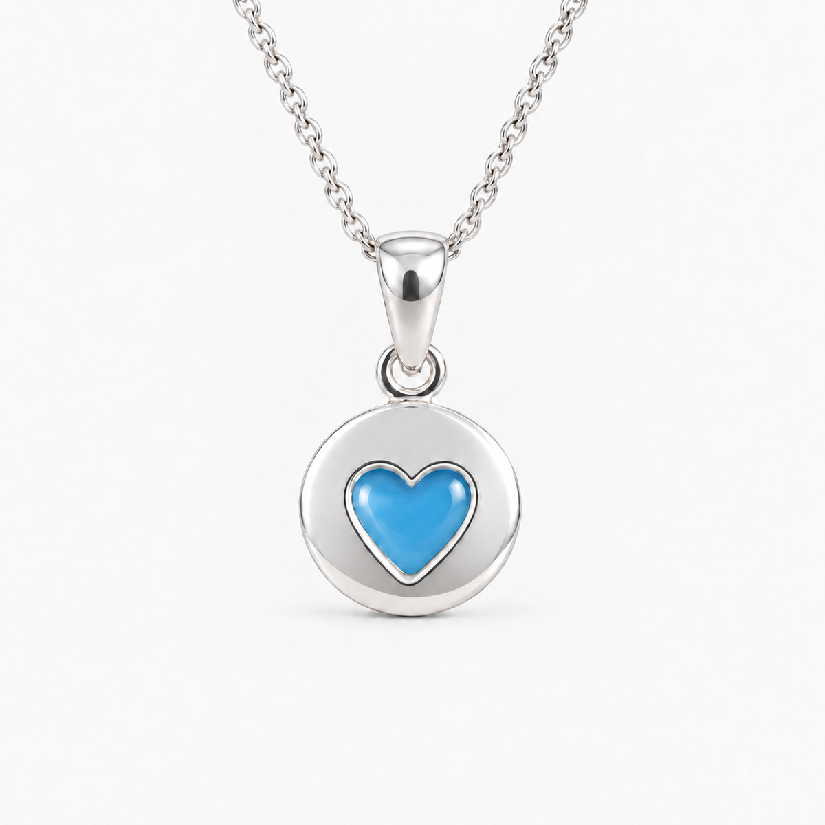 Tiny Heart Disc Ashes Necklace in Sky Blue with hidden inclusions