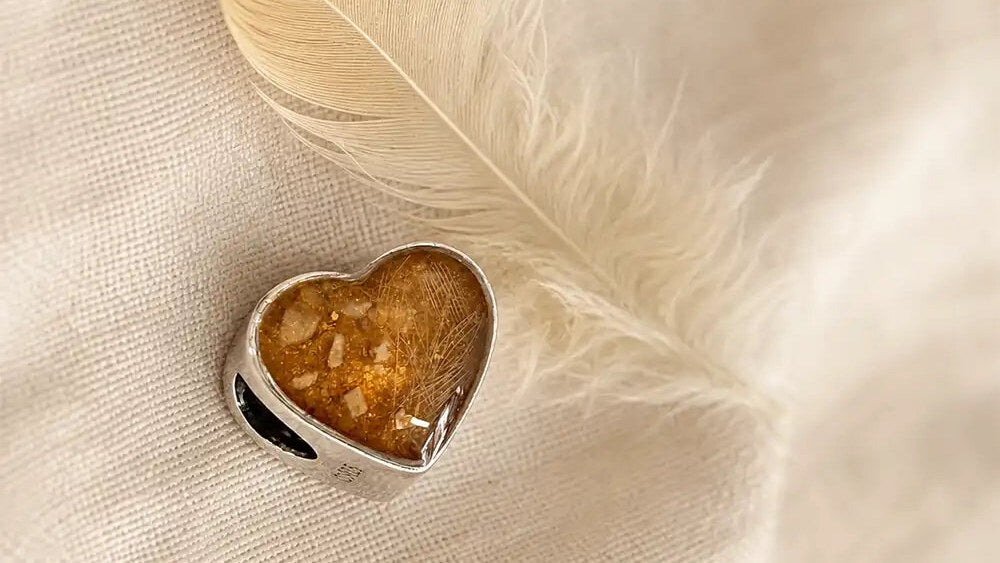 Heart memorial charm made with Bird the chicken’s ashes and feather