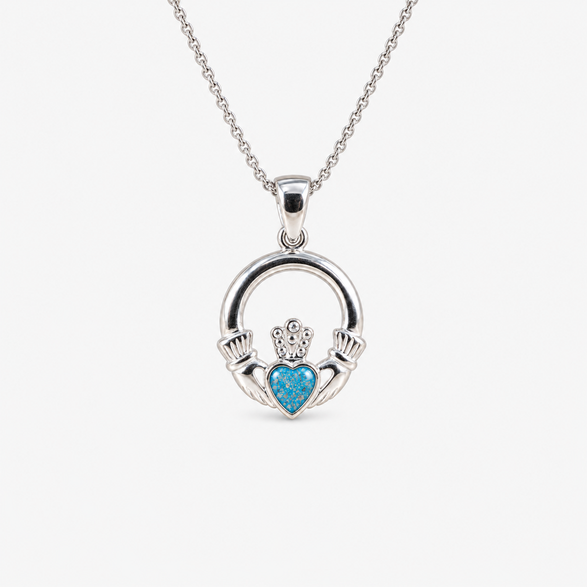 Claddagh Ashes Necklace in Sky Blue with visible ashes
