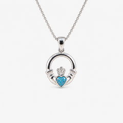 Claddagh Ashes Necklace in Sky Blue with visible ashes
