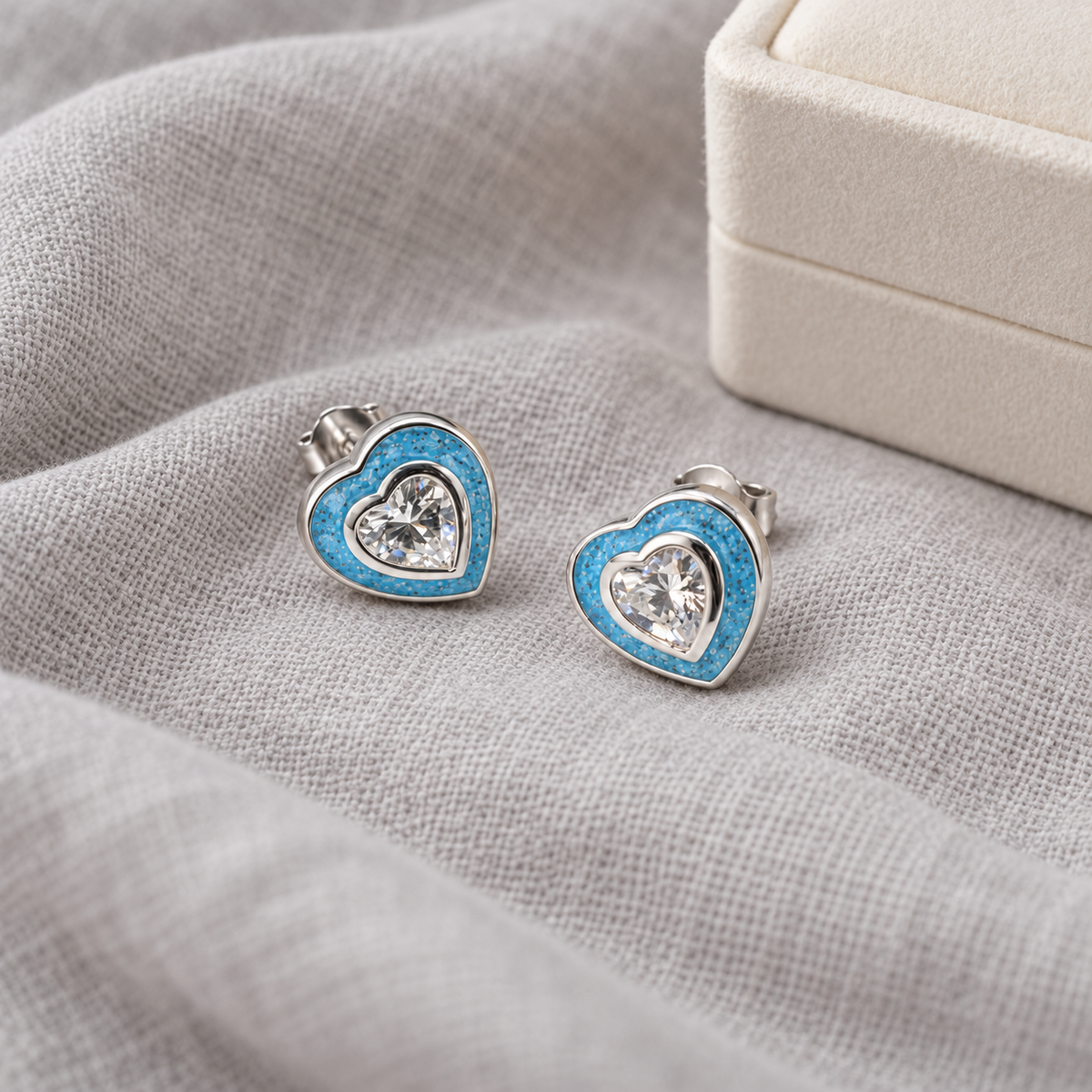 crystal heart ashes earrings in Sky Blue, shown at natural scale