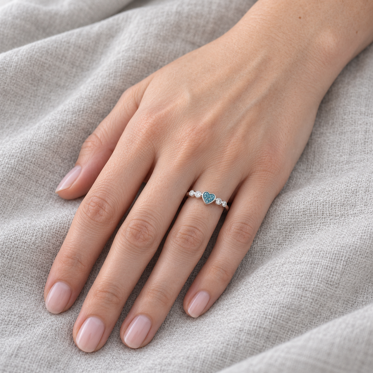 dainty heart ashes ring in Sky Blue, shown at natural scale