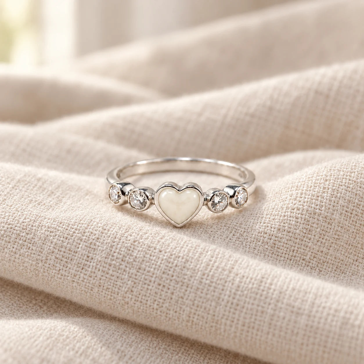 Dainty Heart Breast Milk Ring on pale linen — illustrative milk jewellery preview