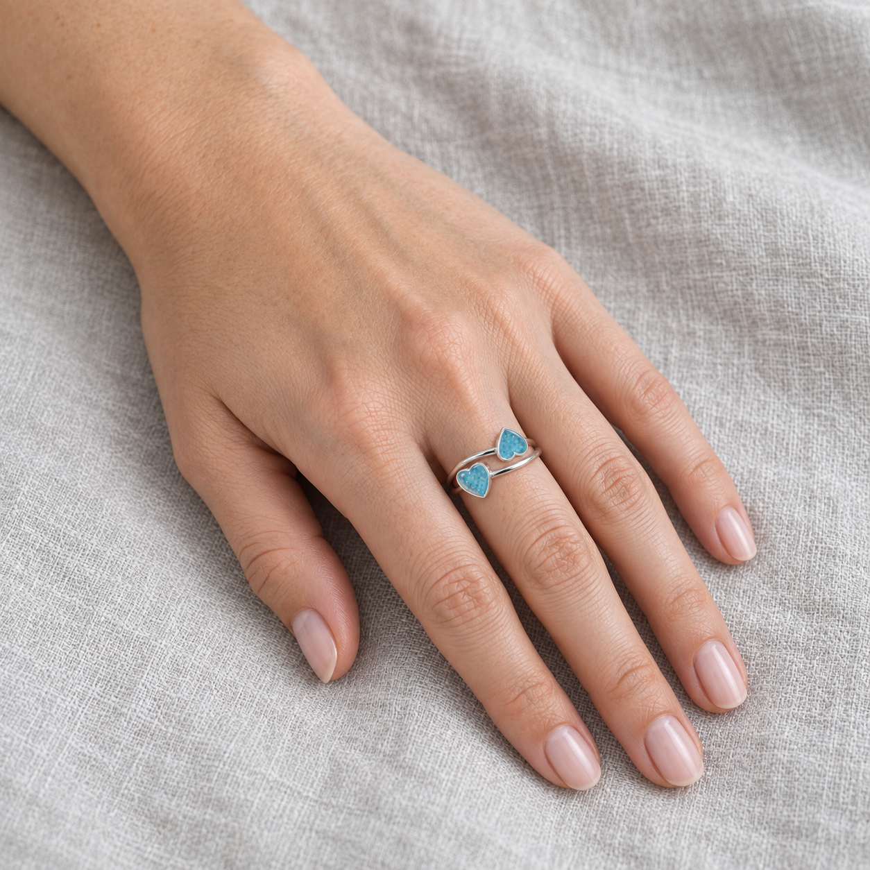 double heart ashes ring in Sky Blue, shown at natural scale