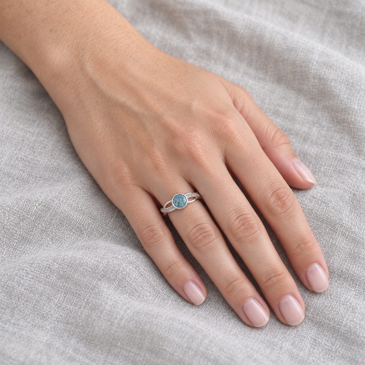 entwined ashes ring in Sky Blue, shown at natural scale