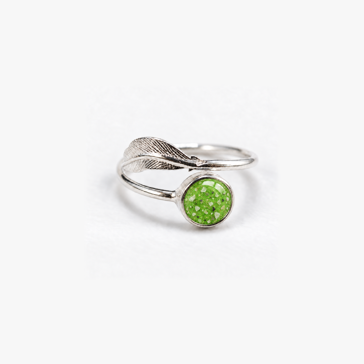 Feather Ashes Ring in Apple Green with visible ashes