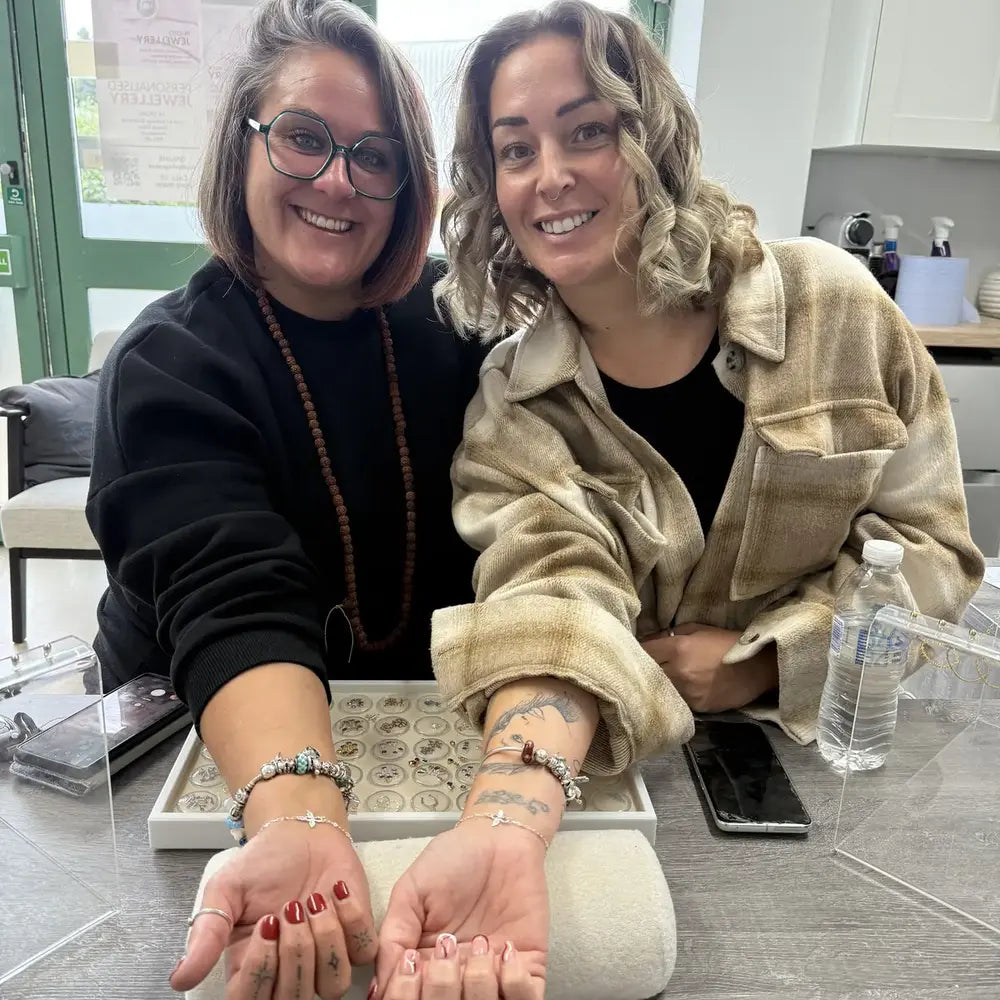 Friends wearing matching welded permanent bracelets at Featherlings