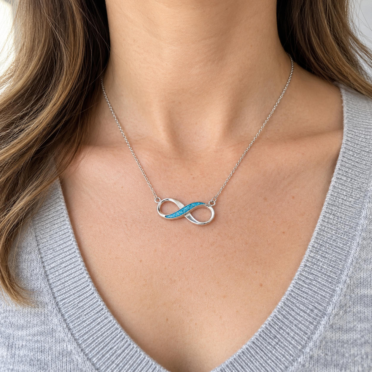 Infinity Ashes Necklace worn, illustrative Sky Blue finish
