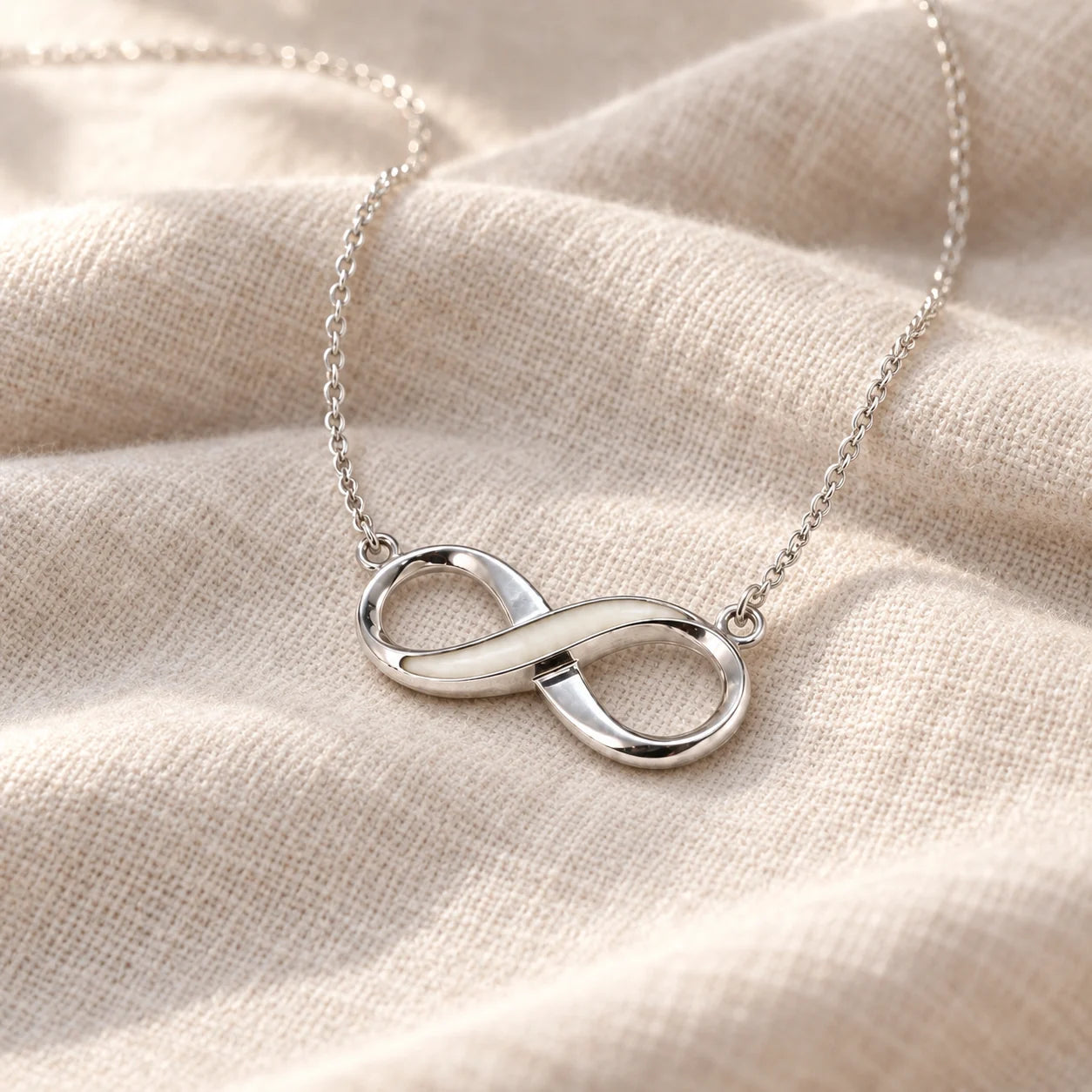Infinity Breast Milk Necklace on pale linen — illustrative preview