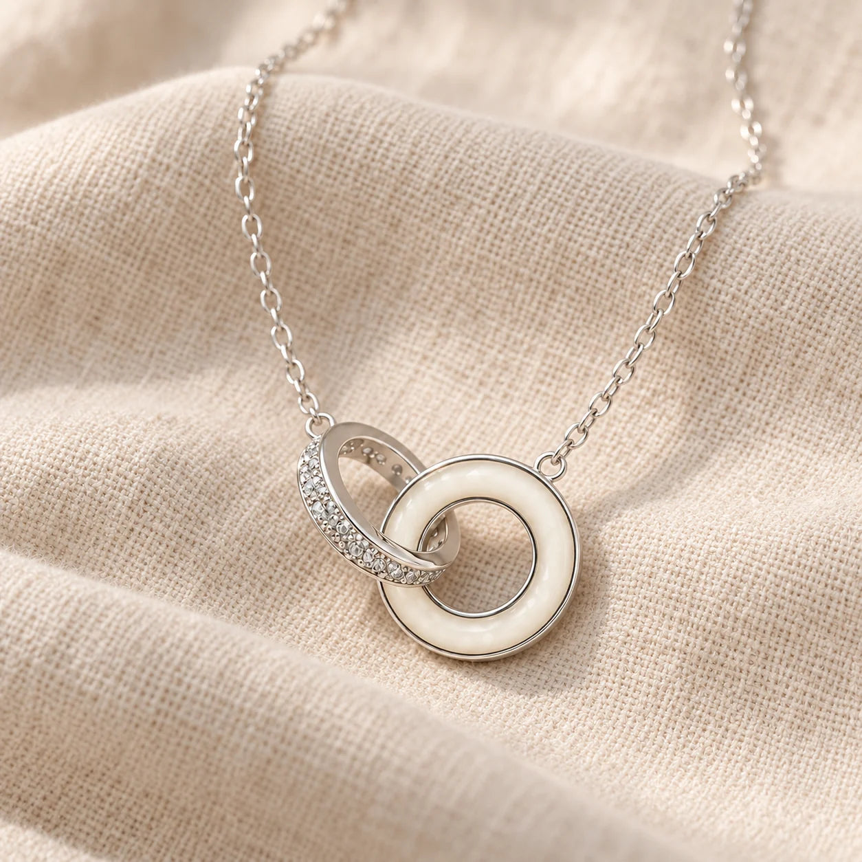 Linked Circles Breast Milk Necklace on pale linen — illustrative preview