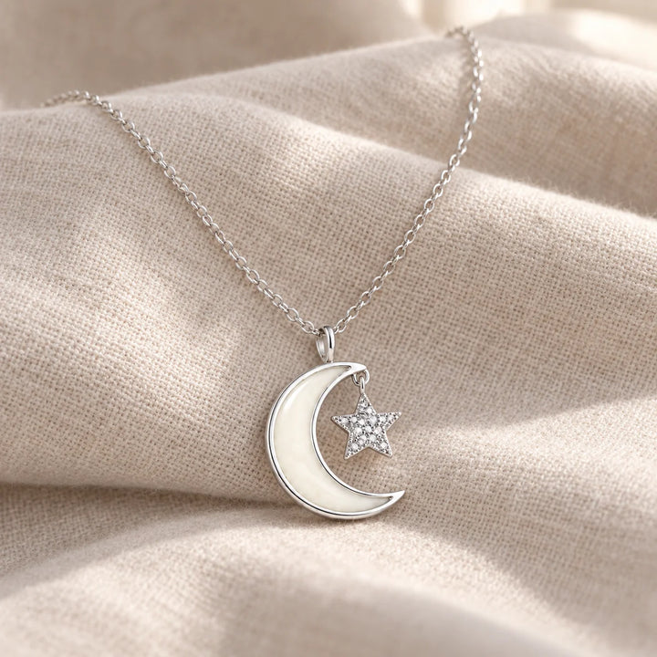 Moon and Star Breast Milk Necklace on pale linen — illustrative preview