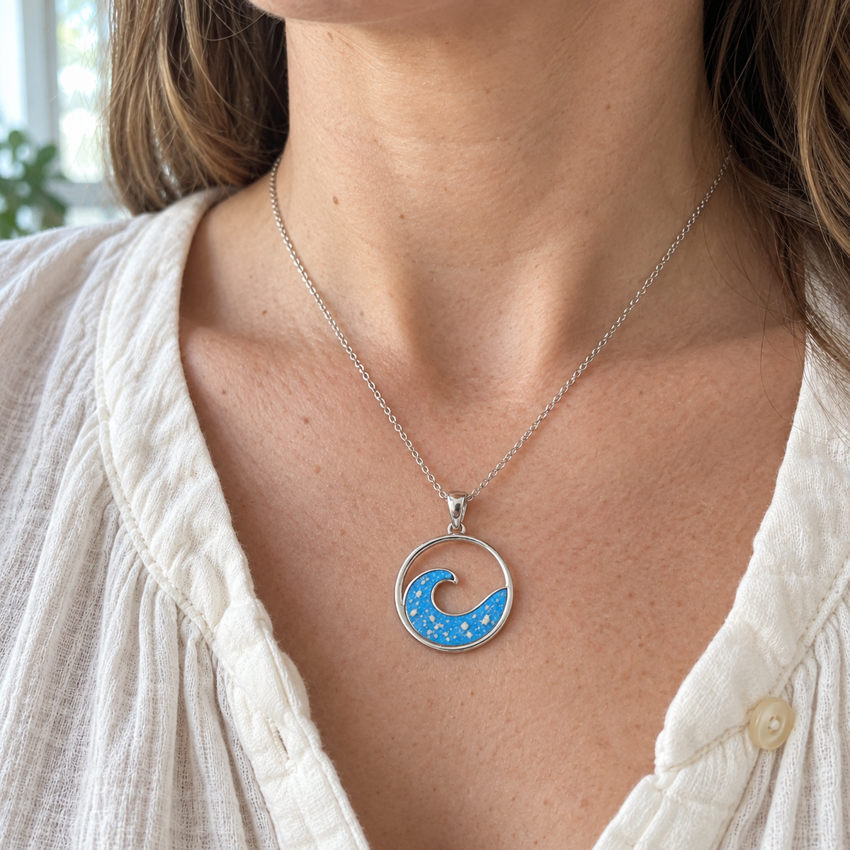 Illustrative worn view of Ocean Wave Ashes Necklace in Sky Blue
