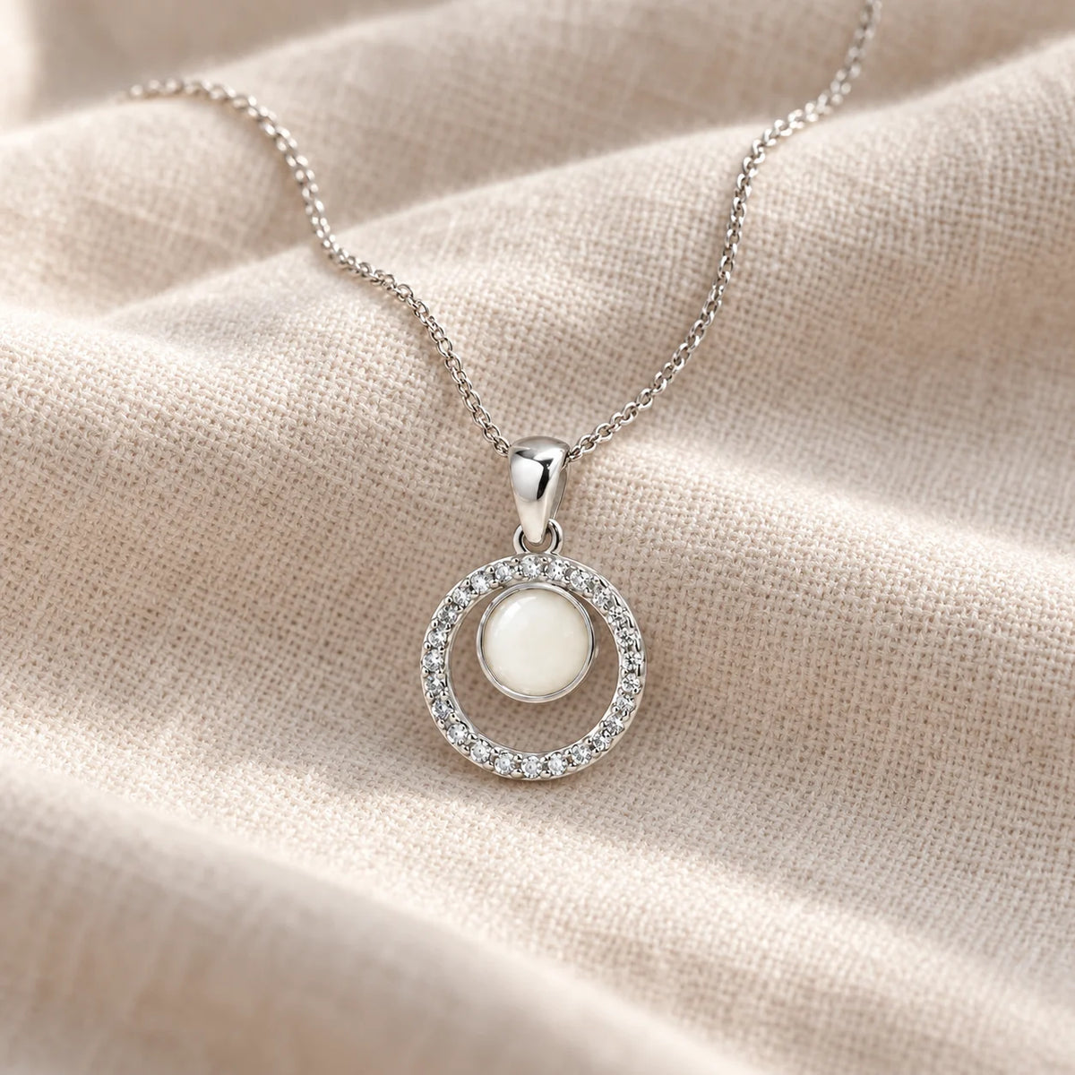 Orbit Halo Breast Milk Necklace on pale linen — illustrative preview