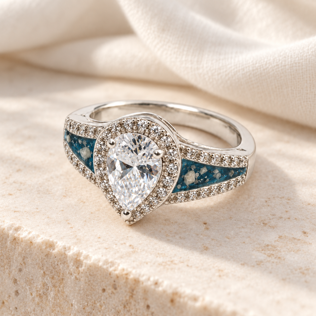 Illustrative lifestyle view of Pear CZ Ashes Ring in Sky Blue