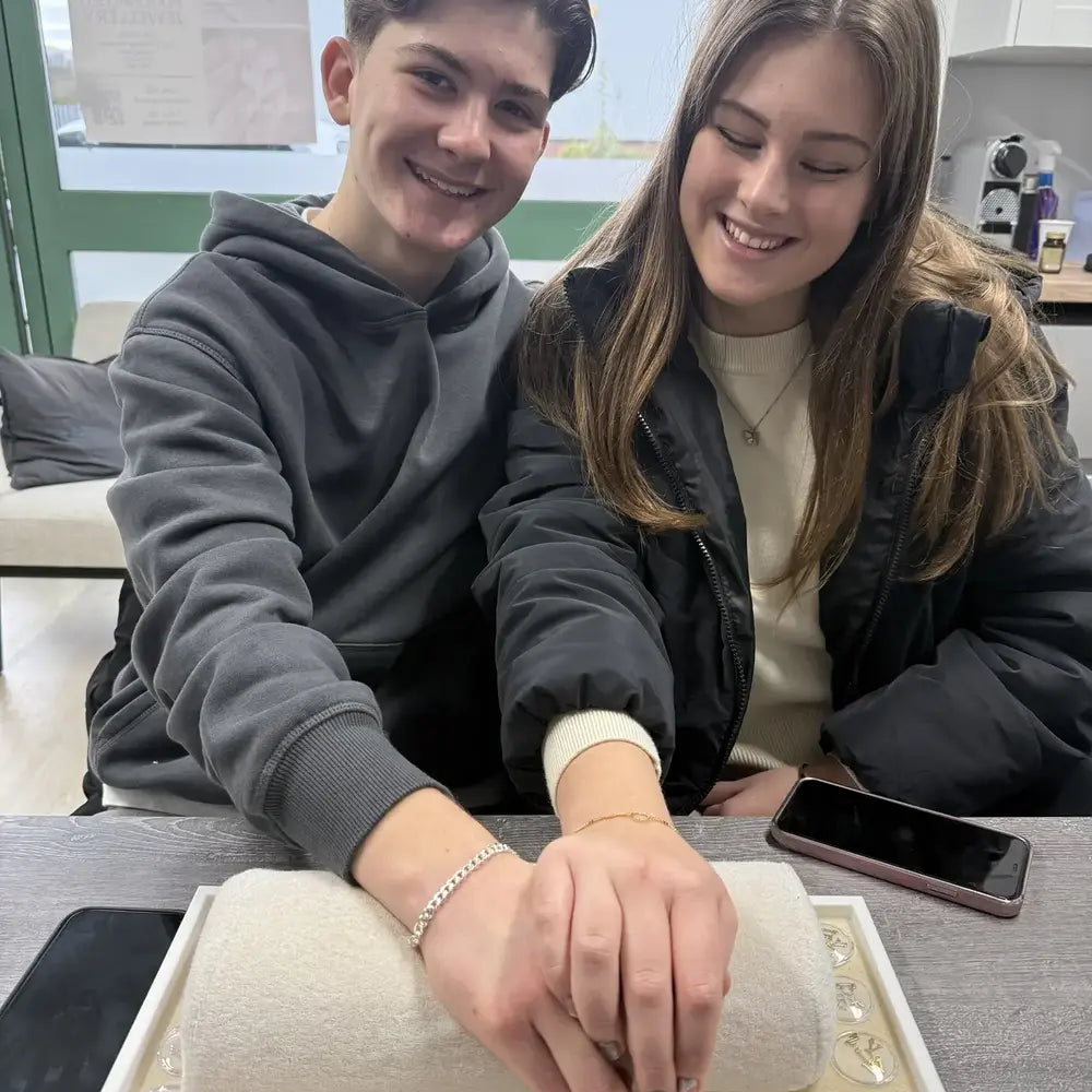 Couple showing their permanent bracelets after an appointment in Portsmouth
