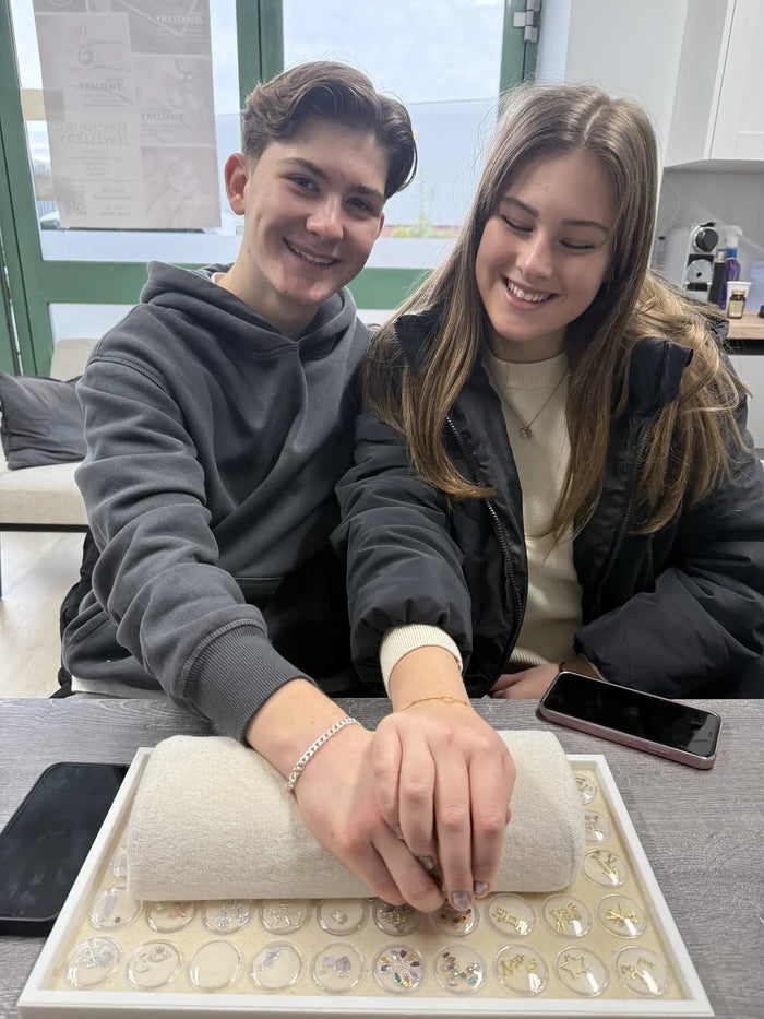 Couple showing their matching permanent bracelets