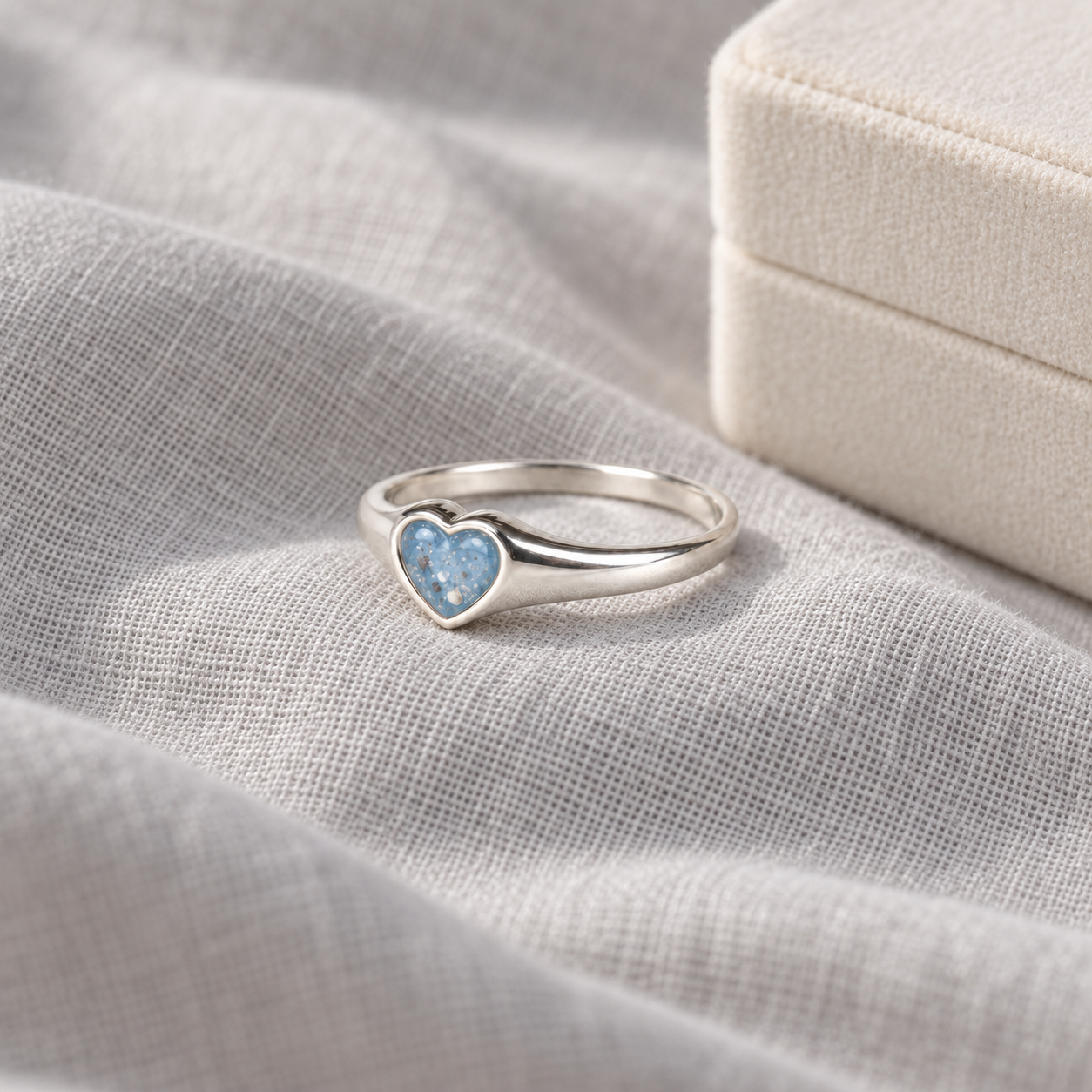Petite Heart Ashes Ring in Sky Blue on linen
