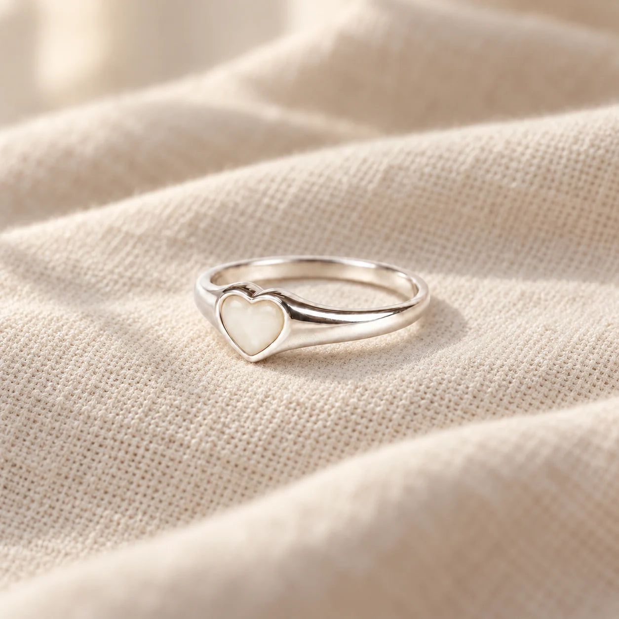 Petite Heart Breast Milk Ring on pale linen — illustrative preview