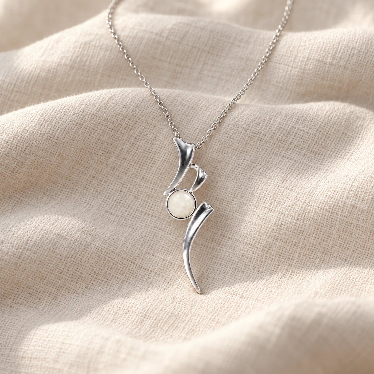 Ribbon Breast Milk Necklace on pale linen — illustrative preview