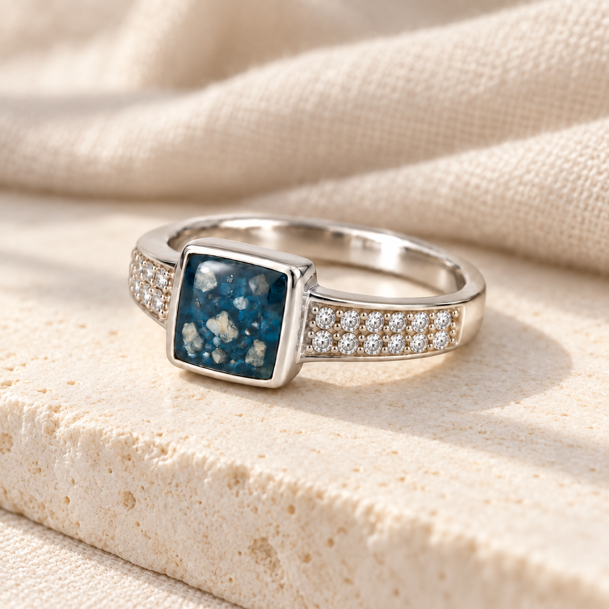 Illustrative lifestyle view of Square Crystal Ashes Ring in Sky Blue, visible ashes
