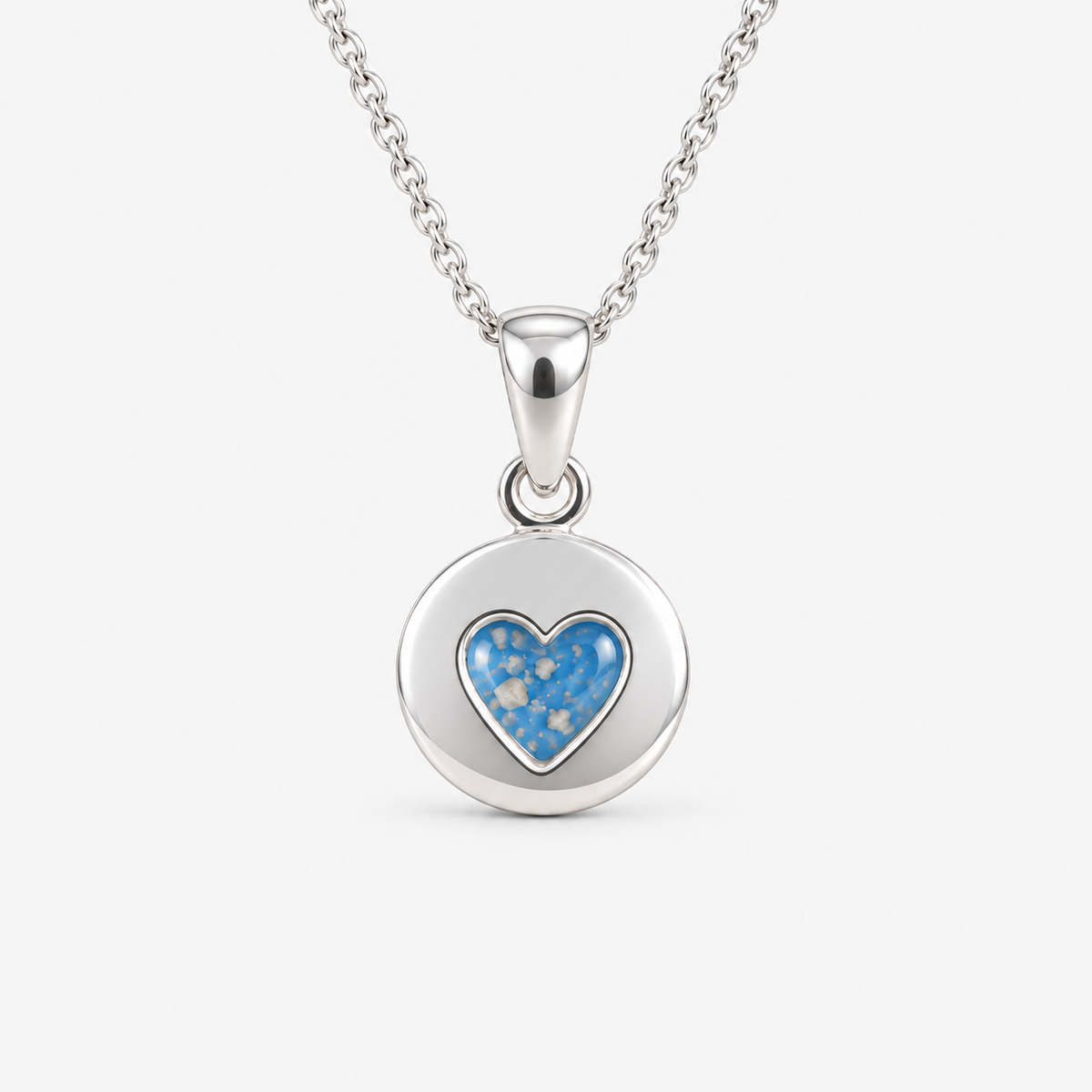 Tiny Heart Disc Ashes Necklace in Sky Blue with visible ashes