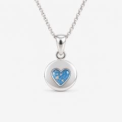 Tiny Heart Disc Ashes Necklace in Sky Blue with visible ashes