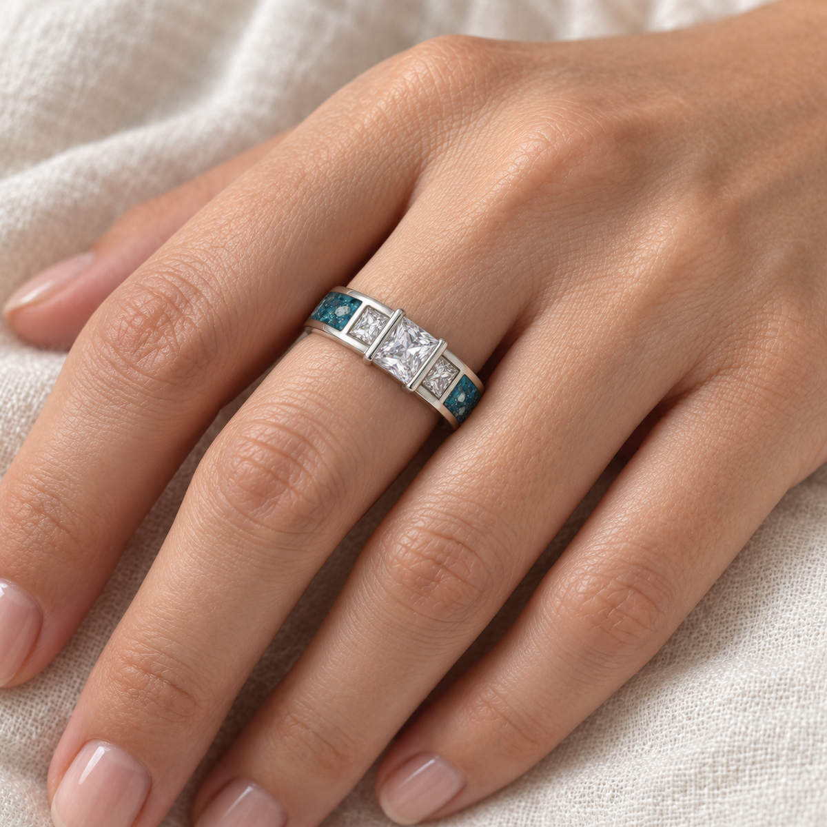 Illustrative worn view of Trilogy Ashes Ring in Sky Blue, visible ashes